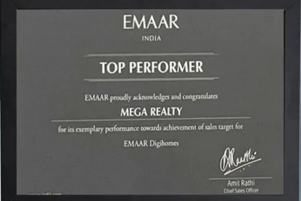 A black framed plaque from Emaar India recognizing Mega Realty as a "Top Performer" for exemplary performance towards achievement of sales target for Emaar Digihomes. Signed by Amit Rathi, Chief Sales Officer.