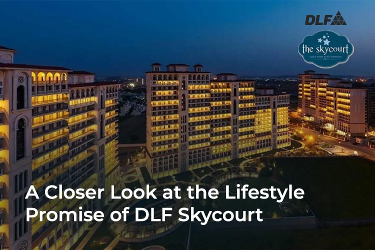 Nighttime view of DLF Skycourt residential complex with illuminated high-rise buildings and landscaped pathways