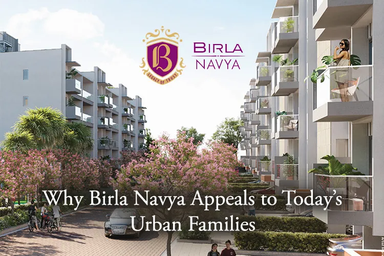Modern residential complex at Birla Navya with landscaped pathway, blooming pink trees, and glass-balconied apartments.