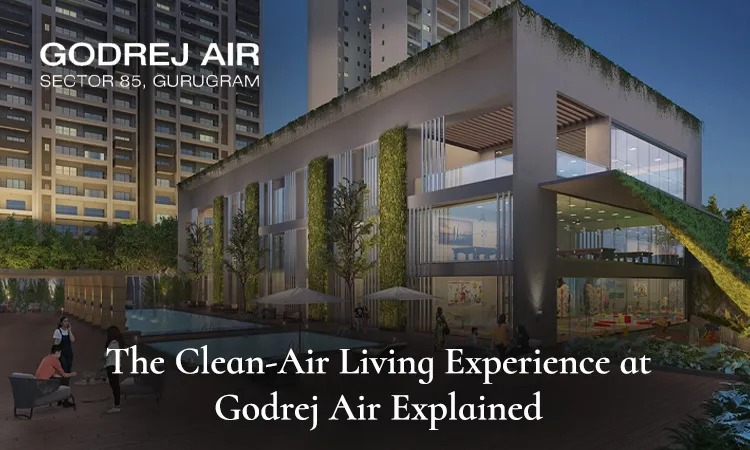 Godrej Air Sector 85 Gurugram clubhouse with vertical gardens, swimming pool, and illuminated towers at dusk. Text overlay reads 