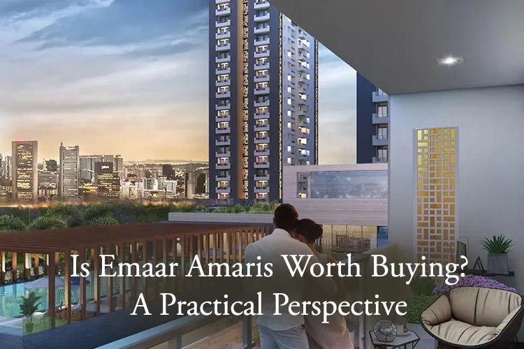 Couple on balcony overlooking Emaar Amaris luxury apartments with pool and landscaped surroundings at dusk.