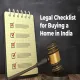 Notepad with legal checklist and judge's gavel on wooden table, titled 'Legal Checklist for Buying a Home in India'