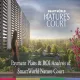 Aerial view of SmartWorld Nature's Court residential towers surrounded by lush greenery, with a woman overlooking the landscaped development from a balcony.