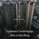 Aerial view of Godrej Miraya's tall bronze-toned residential towers surrounded by lush greenery in Sector 43, Gurgaon, with the project logo and blog title overlay "Top Reasons to Consider Buying a Home at Godrej Miraya"