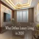 Elegant luxury living room in 2026 featuring marble accent wall, gold chandelier, modular sectional sofa, and warm ambient lighting.