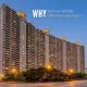 Luxury high-rise residential towers at dusk showcasing low-density living with spacious layouts and lush green surroundings.