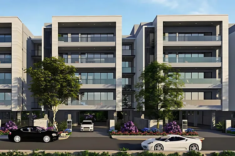 Front view of DLF Imperial Residences, showcasing its modern architecture, spacious balconies with glass railings, and a grand entrance with luxury cars parked outside in Gurugram.
