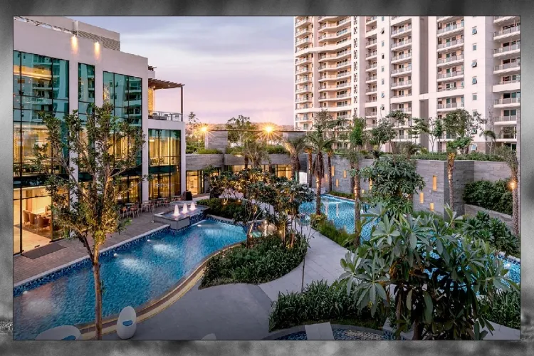 A vibrant evening view of the expansive swimming pool area and modern clubhouse at DLF The Arbour residential complex in Sector 63, Gurgaon, featuring lush landscaping and illuminated high-rise towers.