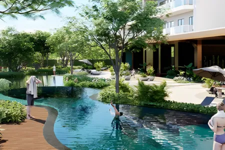 AIPL Riviera – Lagoon Pool with Lush Greenery and Resort Ambience Winding lagoon-style pool at AIPL Riviera surrounded by greenery, lounge chairs, and modern architecture