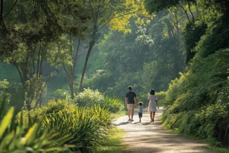 AIPL Riviera – Family Nature Walk Amid Lush Greenery at Lake City Family walking along a forested path surrounded by greenery near AIPL Riviera residential complex