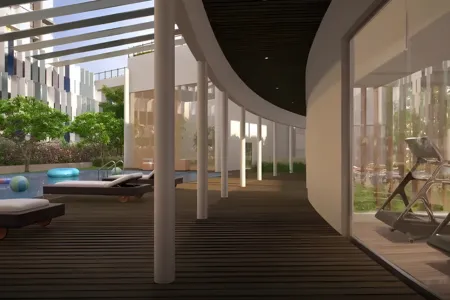 Birla Arika Fitness Center and Outdoor Recreation Deck Outdoor leisure deck at Birla Arika with pool, lounge chairs, and glass-walled fitness center