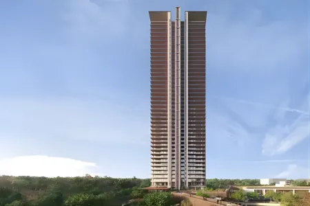Birla Arika Tower Elevation with Landscaped Surroundings Tall modern residential tower at Birla Arika with vertical design and lush greenery