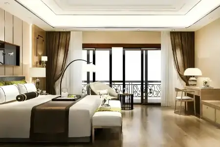 Central Park 104 – Tranquil Sophistication in Gurugram’s Refined Bedrooms Luxurious bedroom at Central Park 104 Gurugram featuring a large bed, elegant seating area, desk, and balcony with classic railings