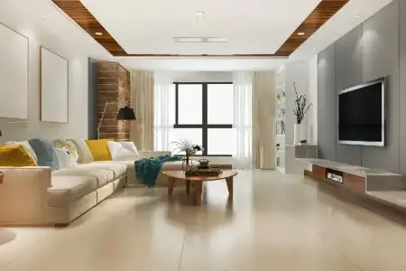 Central Park 104 – Minimalist Elegance in Gurugram’s Contemporary Living Spaces Modern living room at Central Park 104 Gurugram featuring beige sectional sofa, colorful throw pillows, round coffee table, and wall-mounted TV