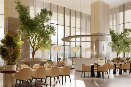 Emaar India Business Centre – Luxury Atrium Cafe and Dining Lounge Spacious luxury cafe and dining area inside Emaar India Business Centre with indoor trees and natural light