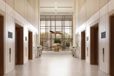 Emaar India Business Centre – Designer Elevator Lobby and Lift Core Symmetrical elevator lobby corridor at Emaar India Business Centre with artistic sculpture and warm lighting