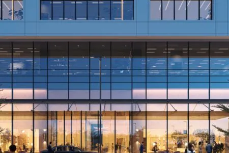 Emaar India Business Centre – Transparent Ground Floor Retail & Office Frontage Illuminated ground floor glass curtain wall of Emaar India Business Centre at dusk with visible interiors