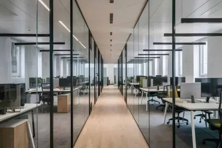 Emaar India Business Centre – Modern Open-Plan Office Space with Glass Partitions Contemporary open-plan office interior at Emaar India Business Centre with glass cubicle partitions and workstations