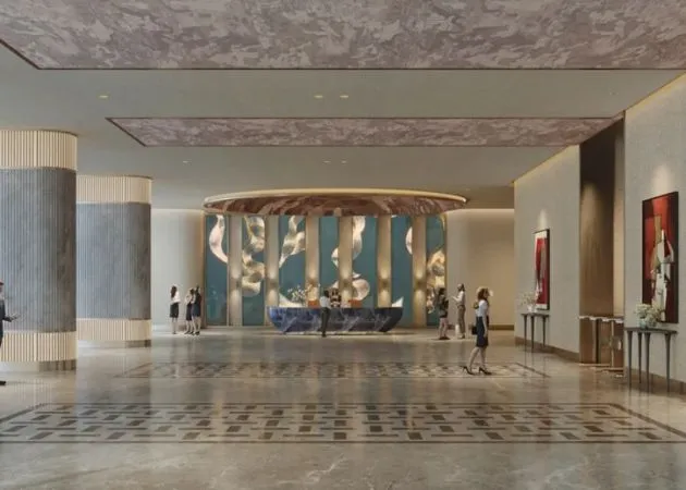 Landmark One Grand Lobby Reception Interior Luxurious lobby interior at Landmark One with a curved reception desk, a decorative teal wall panel with sculptural white accents, fluted stone columns, patterned marble flooring, framed artwork, and people at the reception counter.