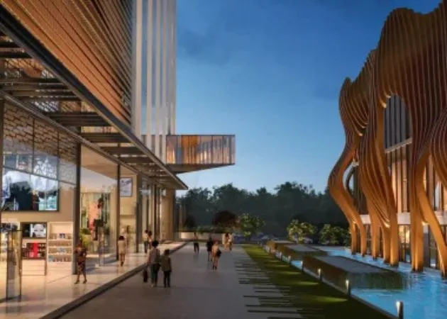 Landmark One Retail Boulevard at Evening Evening view of the Landmark One retail boulevard with illuminated storefronts, people walking along the promenade beside a water feature, and a sculptural gold facade with a flowing, curtain-like architectural design.