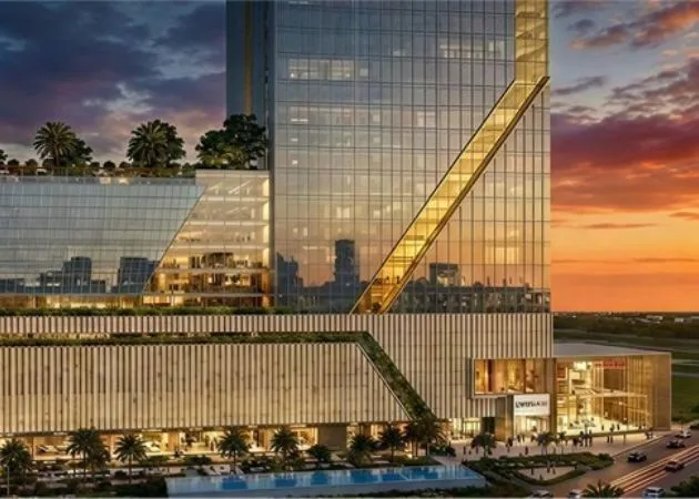 Landmark One Tower at Sunset with Rooftop Garden Landmark One commercial tower at sunset with a diagonal gold accent line across the glass facade, a rooftop garden with palm trees, illuminated ground-floor retail entrance, and a swimming pool lined with palm trees.