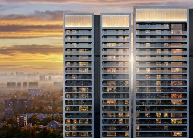 Exterior view of Godrej Verano high-rise luxury residential towers lit up against a golden sunset in Sector 63A Gurugram.