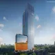 Dusk view of the Landmark One in Sector 67, Gurgaon, glass tower with a copper-toned podium base and greenery in the foreground, labeled as an artistic impression in the bottom corner.