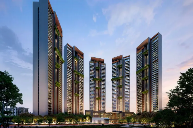 An exterior view of five modern residential towers of Signature Global Cloverdale SPR, showcasing their sleek design, vertical green elements, and illuminated facades against a twilight sky.