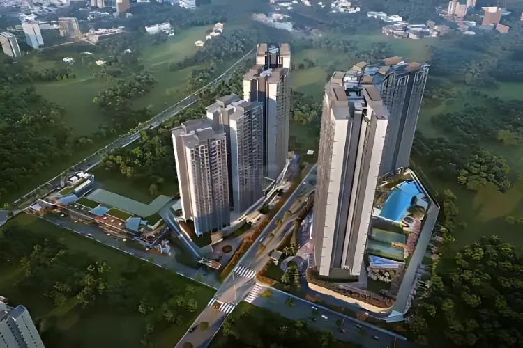 An aerial perspective of a cluster of modern high-rise residential towers at Signature Global Deluxe DXP in Gurugram, showcasing integrated swimming pools, amenity areas, and lush green landscaping surrounding the buildings, with roads visible.