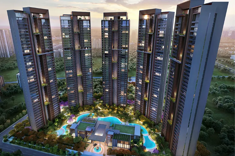 Aerial view of Signature Global Titanium SPR showing multiple modern high-rise residential towers, a large central amenity area with swimming pools, lush green landscaping, and clubhouses, all under a vibrant sky.